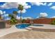 Beautiful pool and spa with lush landscaping and palm trees, ideal for outdoor relaxation at 1905 E Palomino Dr, Gilbert, AZ 85296