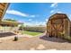 Spacious backyard featuring turf area, shed, block fence, and covered patio at 19661 N Central Ave, Phoenix, AZ 85024