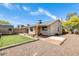 Backyard view of the house with a covered patio, artificial lawn, and a shed at 19661 N Central Ave, Phoenix, AZ 85024