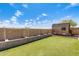 Well-kept backyard with an artificial lawn, a shed, and cinder block walls at 19661 N Central Ave, Phoenix, AZ 85024
