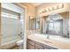Bathroom with a large mirror, vanity, shower and tub combination, and neutral finishes at 19661 N Central Ave, Phoenix, AZ 85024