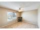 Bedroom featuring a ceiling fan, tile floors, a rock fireplace, and a large window at 19661 N Central Ave, Phoenix, AZ 85024