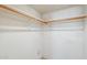 Walk-in closet with white walls and wooden clothing racks at 19661 N Central Ave, Phoenix, AZ 85024