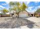 Charming single-story home featuring a two-car garage, desert landscaping, and a mature shade tree at 19661 N Central Ave, Phoenix, AZ 85024