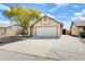 Charming single-story home with a two-car garage, desert landscaping, and a mature shade tree at 19661 N Central Ave, Phoenix, AZ 85024