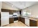 Well-lit kitchen with granite counters, white appliances, and tiled flooring at 19661 N Central Ave, Phoenix, AZ 85024