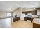 Open-concept kitchen featuring granite countertops, white appliances, track lighting, and adjacent living area at 19661 N Central Ave, Phoenix, AZ 85024