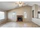 Open living area with vaulted ceiling, brick fireplace, ceiling fan, and tiled flooring throughout at 19661 N Central Ave, Phoenix, AZ 85024
