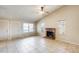 Inviting living room featuring a brick fireplace, tiled flooring, and a ceiling fan at 19661 N Central Ave, Phoenix, AZ 85024
