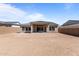 Expansive backyard with a covered patio, block wall, and ample space for outdoor activities at 20209 W San Miguel Ave, Litchfield Park, AZ 85340