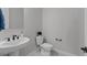 Stylish powder room showcasing modern fixtures, a pedestal sink, and neutral decor at 20209 W San Miguel Ave, Litchfield Park, AZ 85340