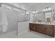 Bright bathroom showcasing a double vanity and a spacious walk-in shower with marble-style tiling at 20209 W San Miguel Ave, Litchfield Park, AZ 85340