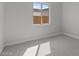 Bright bedroom showcasing plush carpeting, neutral paint, and a window at 20209 W San Miguel Ave, Litchfield Park, AZ 85340
