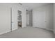 Spacious bedroom featuring neutral carpet, an ensuite bathroom, and ample closet space at 20209 W San Miguel Ave, Litchfield Park, AZ 85340