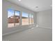 Sunlit bedroom with plush carpeting, and large windows overlooking the neighborhood at 20209 W San Miguel Ave, Litchfield Park, AZ 85340