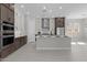 Well-lit modern kitchen with stainless steel appliances, central island, and two-tone cabinetry at 20209 W San Miguel Ave, Litchfield Park, AZ 85340
