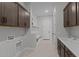 Functional mud room featuring custom cabinets, built in shelving and a sink with matching hardware at 20209 W San Miguel Ave, Litchfield Park, AZ 85340