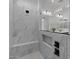 Modern walk-in shower features marble style tiles, a built in bench, and a glass partition at 20209 W San Miguel Ave, Litchfield Park, AZ 85340