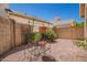 Landscaped backyard featuring a decorative plant stand and gravel ground cover at 2039 W Ronald Rd, Phoenix, AZ 85029