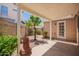 Outdoor patio with decorative landscaping, mature shade tree, and covered seating area at 2039 W Ronald Rd, Phoenix, AZ 85029