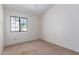 Simple bedroom with a window providing natural light and ceiling fan at 2039 W Ronald Rd, Phoenix, AZ 85029