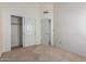 A comfortable bedroom with closet and an open door offers a inviting and airy atmosphere at 2039 W Ronald Rd, Phoenix, AZ 85029