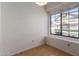 Bedroom with wood flooring, window with view of yard, and fresh paint at 2039 W Ronald Rd, Phoenix, AZ 85029