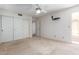 A carpeted bedroom with sliding closet doors and an ceiling fan for added convenience at 2039 W Ronald Rd, Phoenix, AZ 85029