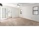 A carpeted bedroom features two windows and a ceiling fan, offering a comfortable space at 2039 W Ronald Rd, Phoenix, AZ 85029