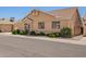 Street view of a tan single-Gathering home with manicured bushes, window box, and a side gate at 2039 W Ronald Rd, Phoenix, AZ 85029