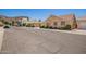 Street view of a tan single-Gathering home with manicured bushes and mountain backdrop at 2039 W Ronald Rd, Phoenix, AZ 85029