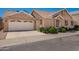 Tan single-Gathering home with a two-car garage, well-maintained landscaping, and a paved driveway at 2039 W Ronald Rd, Phoenix, AZ 85029