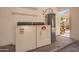 The garage has utility hookups, storage shelves, and an exit door at 2039 W Ronald Rd, Phoenix, AZ 85029