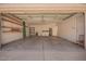 Spacious garage interior with built-in shelving, laundry appliances, and access to the home's interior at 2039 W Ronald Rd, Phoenix, AZ 85029