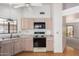 Traditional kitchen with wood cabinets, laminate counters, and a black appliance package at 2039 W Ronald Rd, Phoenix, AZ 85029