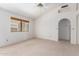 Living room with carpet flooring, fan, and window with view of enclosed patio at 2039 W Ronald Rd, Phoenix, AZ 85029
