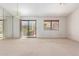 Bright and airy living room with sliding glass doors and neutral carpet at 2039 W Ronald Rd, Phoenix, AZ 85029
