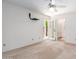 Carpeted main bedroom featuring ceiling fan, access to bathroom, and private access to landscaped backyard at 2039 W Ronald Rd, Phoenix, AZ 85029
