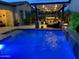 Backyard pool with a covered outdoor living space and a water feature offers an oasis for relaxation and entertainment at 2087 N Park St, Buckeye, AZ 85396