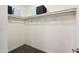 Walk-in closet space featuring carpeting, ample shelving, and overhead storage at 2726 E Fairmount Ave, Phoenix, AZ 85016