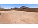 Large backyard with privacy wall, offering a blank canvas for landscaping and outdoor enjoyment at 322 S San Christo Ln, Casa Grande, AZ 85194