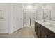 Modern bathroom featuring dual sinks, dark cabinets, and a glass-enclosed shower at 322 S San Christo Ln, Casa Grande, AZ 85194