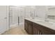 Elegant bathroom with double sinks, dark wood cabinets, and a walk-in shower at 322 S San Christo Ln, Casa Grande, AZ 85194