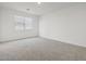 Cozy bedroom featuring neutral carpet, white walls, and a bright window at 322 S San Christo Ln, Casa Grande, AZ 85194