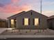 Charming single-story home featuring a red tile roof, desert landscaping, and shuttered windows at 322 S San Christo Ln, Casa Grande, AZ 85194