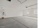 Spacious two-car garage with concrete flooring and water heater on the wall at 322 S San Christo Ln, Casa Grande, AZ 85194