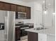 Modern kitchen features granite counters, stainless appliances, a gas range, and dark wood cabinets at 322 S San Christo Ln, Casa Grande, AZ 85194