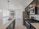 Well-lit kitchen with stainless steel appliances, granite countertops, and a view to the backyard at 322 S San Christo Ln, Casa Grande, AZ 85194
