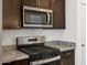 Close-up shot of the kitchen featuring granite counters and stainless steel gas range at 322 S San Christo Ln, Casa Grande, AZ 85194