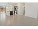 Open floor plan with modern lighting, stainless steel appliances, and sliding glass door to backyard at 322 S San Christo Ln, Casa Grande, AZ 85194